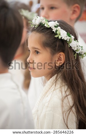 KYIV, UKRAINE - MAY 16, 2015: Little girl during the ceremony of a First Communion in the Church of St. Basil the Great of Ukrainian Greek Catholic Church, on May 16, 2015 in Kyiv, Ukraine.