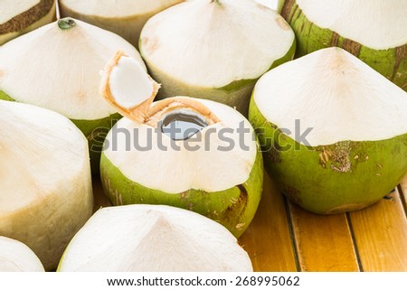 Fresh coconut water drink on wooden table