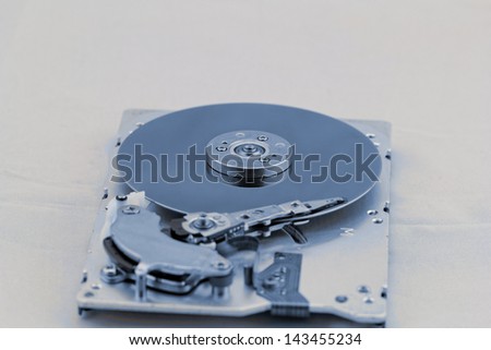 Open computer hard drive on white background with blue (HDD, Winchester)