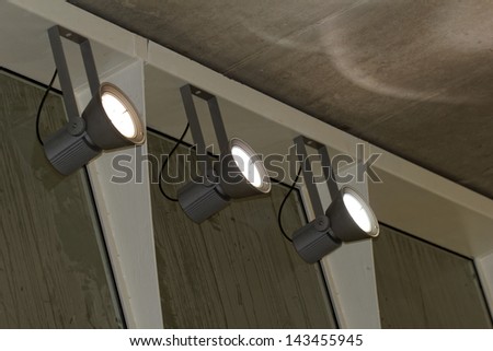 industrial lights on the wall inside a building