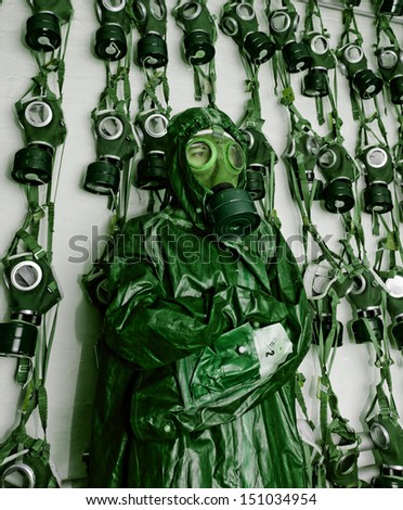 old military gas masks on a soldier woman with chemical protective suit green