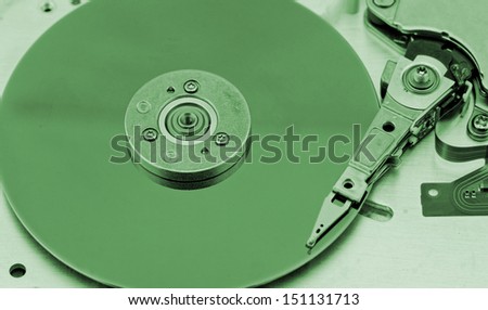Open computer hard drive on white background with green (HDD, Winchester)