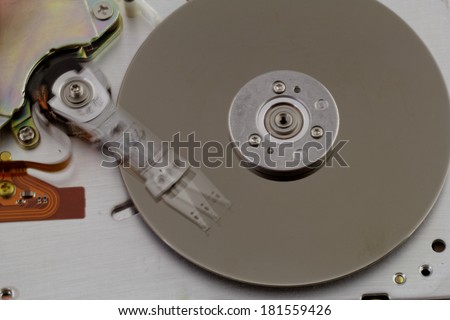 Open computer hard drive on white background with moving head (HDD, Winchester)