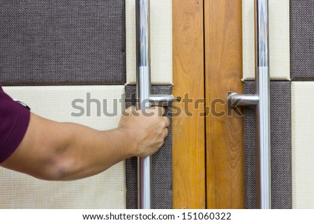 Man`s hand opening door
