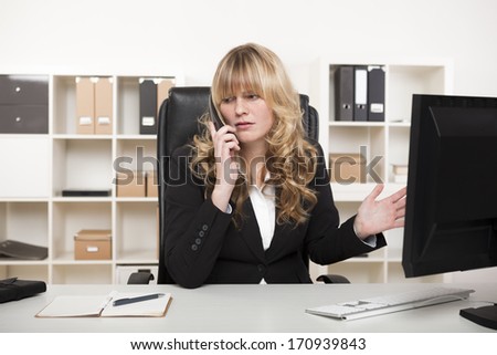 Businesswoman having a discussion on the phone gesturing as she listens to the conversation and disagrees with something being said