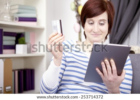portrait of happy young girl with tablet computer shopping for easter gifts at home