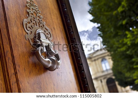 Bronze knocker on the door of a mansion in Bordeaux, France