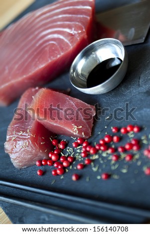 Pieces of raw tuna, soy sauce and spices in a kitchen Japanese restaurant