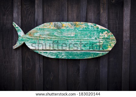 Wooden fish hanging from a wooden hut