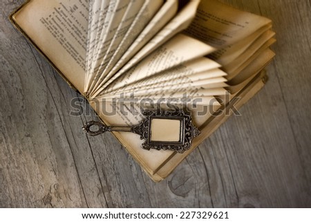 Decorating with an old folded book and a miniature mirror