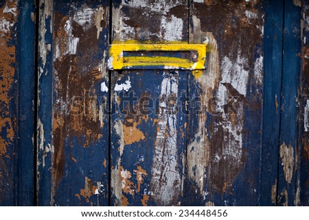 Letter box on an old painted door