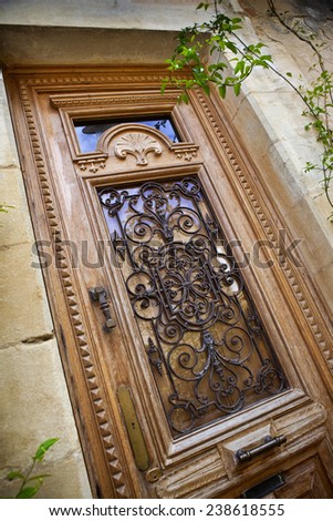 Wooden and wrought iron door of an old French house