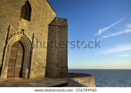 Sunset on church facing the sea at Talmont village, South-West of France