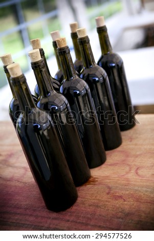 Bottles of red wine in a cellar near Bordeaux, France