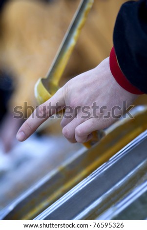 Hand in the process of serving soup