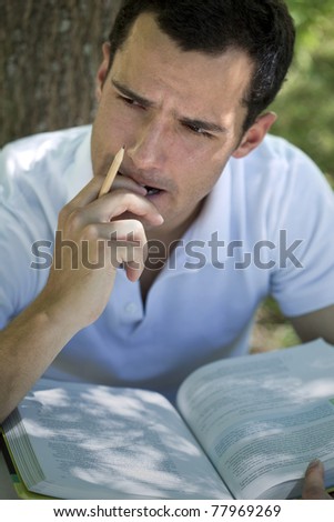 Portrait of a young man studying and thinking