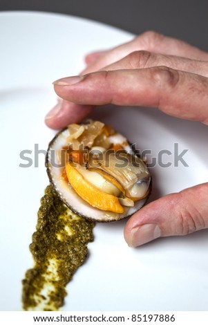 Chef preparing a dish with a pesto and stuffed shells