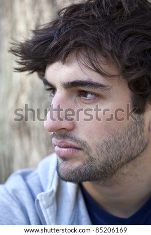 Portrait of a young bearded man in profile