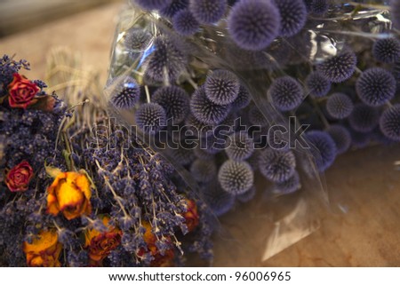 Bouquets of dried roses, lavender and thistles in a market