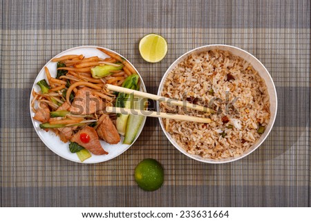 Cooked rice and meat with vegetables on mat