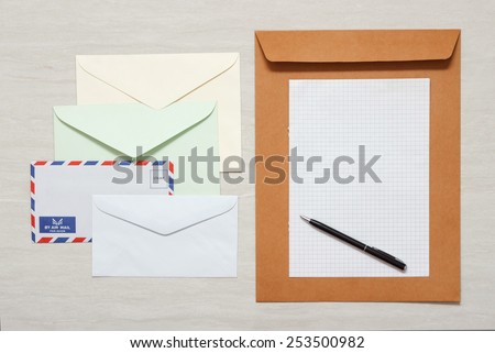 A set of blank envelopes with paper and pen view 1