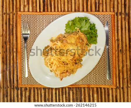 Natural light photo of a plate of pasta topped with cheese top view 1