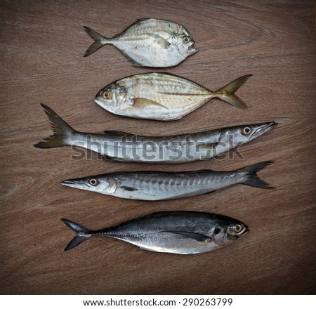 Fresh fish assortment ready for cooking on wooden background, top view 1