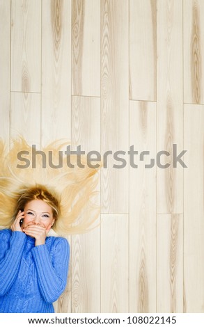 Young woman covered mouth during phone conversation
