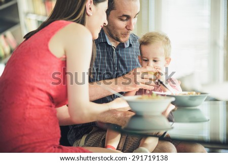 Parents feeding their child