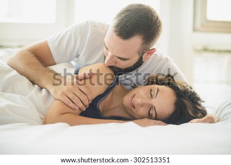 Young man and woman in bed