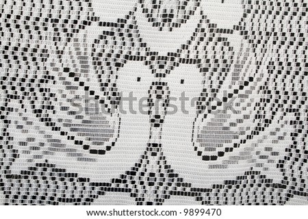 Close-up shot of white lace illustration with two doves