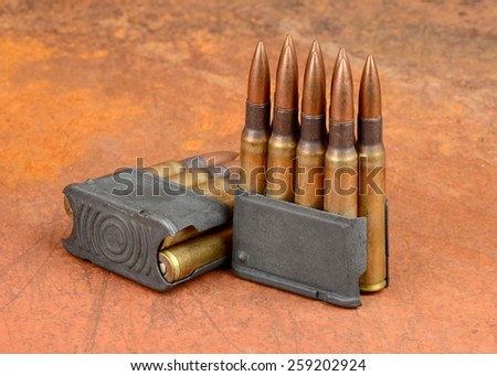 World War II M1  Clips and 30-06 ammunition on rusty background.