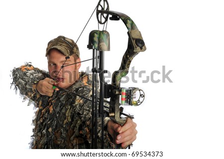 Hunter aims a compound bow and arrow