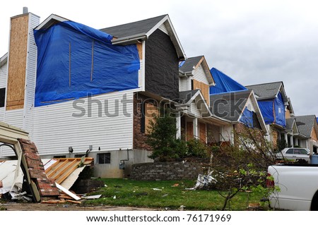 ST. LOUIS - APRIL 25, 2011: Blue tarps testify to tornado damage on house after house. The F3 twister swept through Maryland Heights in the suburbs of St. Louis on Good Friday, April 22, 2011.