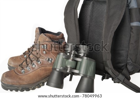 Hiking gear including boots, binoculars and a backpack