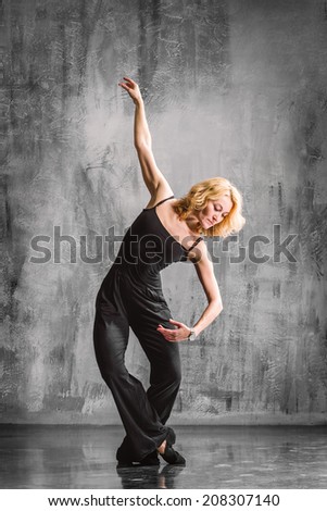 jazz style dancer posing on a studio background