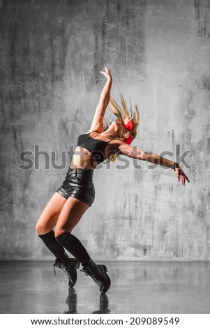 trendy street style dancer jumping on studio background