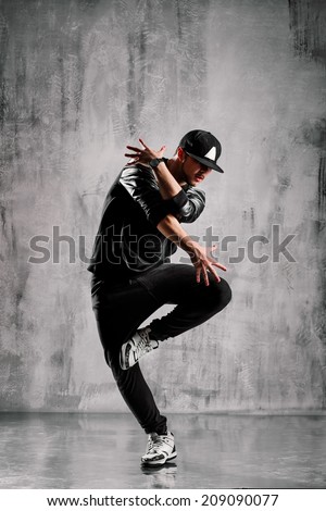 young street style dancer posing on studio background