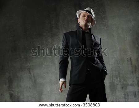 man in black suite and white hat