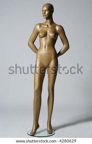 the mannequin standing alone on grey background