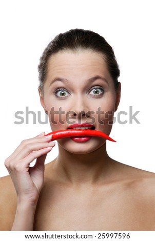portrait of young woman eating chili pepper