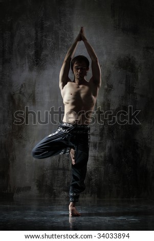 cool yoga man posing on dirty grunge background
