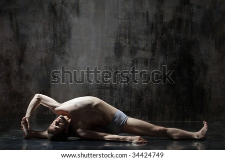 cool yoga man posing on dirty grunge background