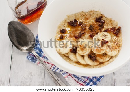 delicious porridge with banana, dates, cinnamon and maple syrup