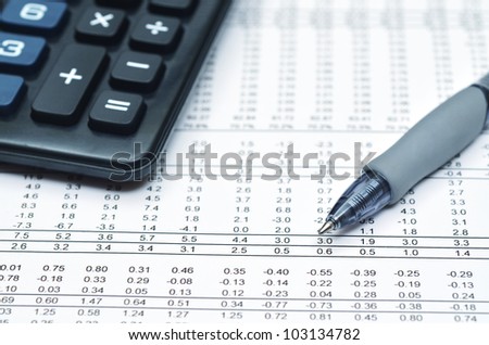 Detailed shot of financial report, ballpoint and calculator. Can be use as Illustration of financial business, math work, accounting, office work, business economy or general business etc.