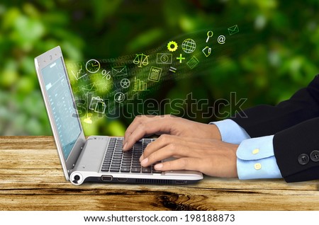 A businessman doing his job with  an internet connected laptop with a green background. Can be use for work from home concept