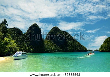 Boat vacation on Tropical Island. This picture taken in one of the most beautiful travel and diving destination on earth. Raja Ampat Island, Papua, Indonesia.