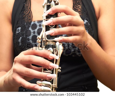 beautiful girl in black dress isolated on white background holding clarinet