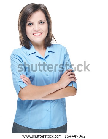 Attractive young woman in a blue blouse. Standing with folded hands. Isolated on white background