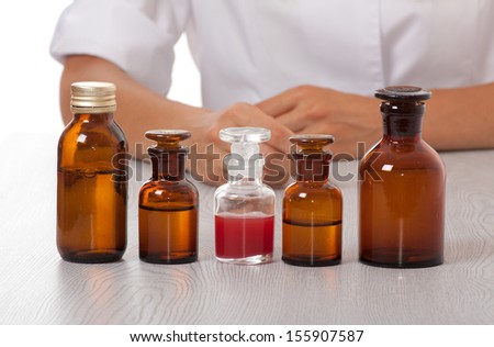 doctor\'s hand with bottles of medicine on the table